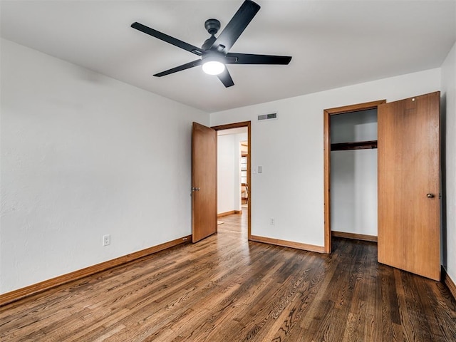 unfurnished bedroom featuring ceiling fan, dark hardwood / wood-style floors, and a closet