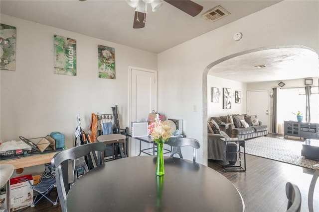 dining area featuring ceiling fan and dark hardwood / wood-style floors