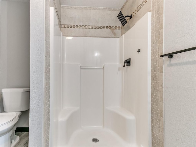 bathroom with toilet and walk in shower