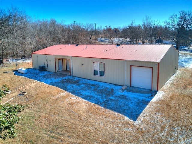 view of front of home featuring central AC and a garage