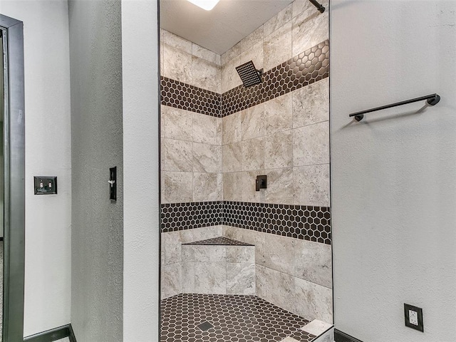 bathroom featuring tiled shower