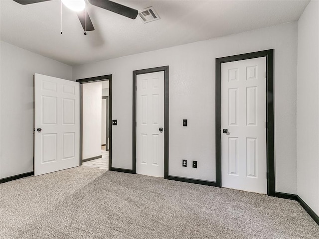 unfurnished bedroom featuring carpet flooring and ceiling fan