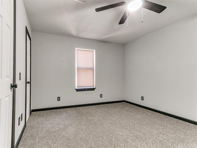 carpeted spare room with ceiling fan