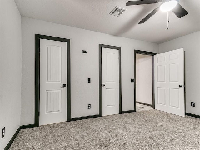 unfurnished bedroom featuring ceiling fan and light carpet