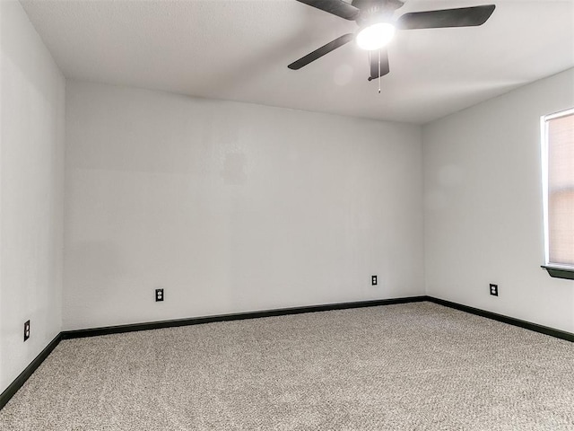 carpeted spare room with ceiling fan