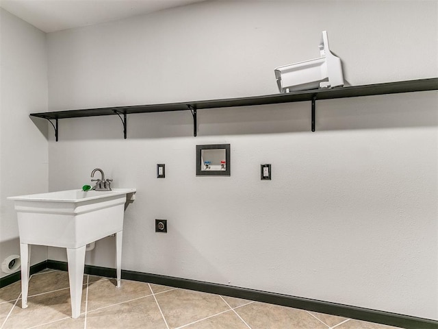 laundry area featuring electric dryer hookup, light tile patterned floors, and hookup for a washing machine