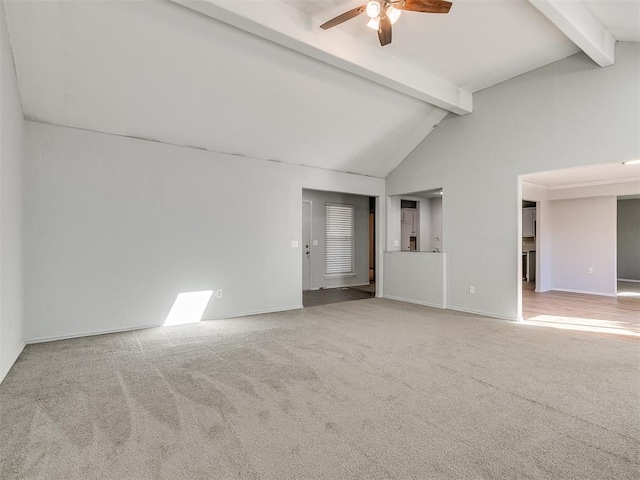 carpeted spare room featuring high vaulted ceiling, ceiling fan, and beam ceiling