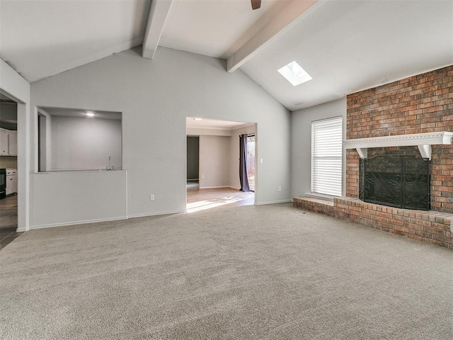 unfurnished living room with lofted ceiling with skylight, a brick fireplace, and carpet floors