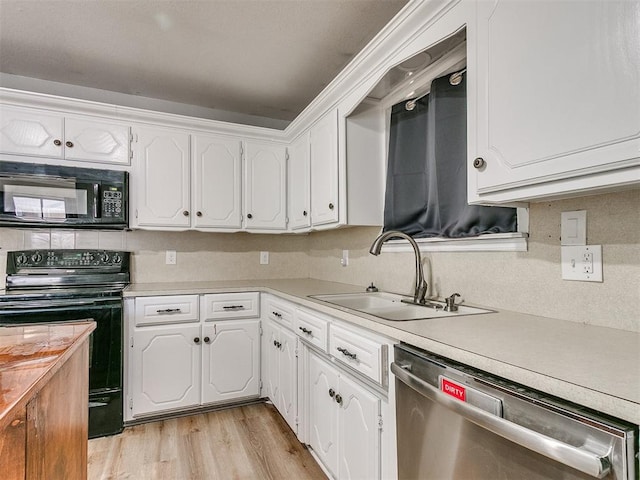 kitchen featuring black appliances, light hardwood / wood-style flooring, white cabinets, and sink