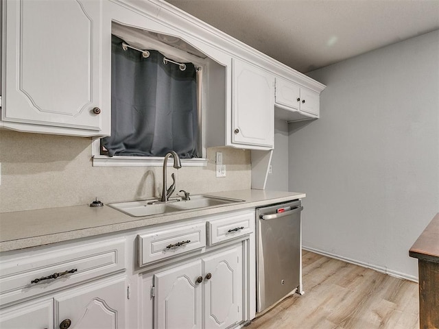 kitchen with sink, white cabinetry, and stainless steel dishwasher