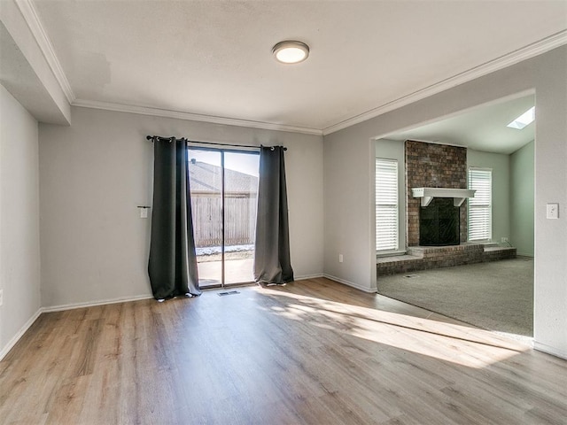 unfurnished living room featuring a brick fireplace, light wood-type flooring, and ornamental molding