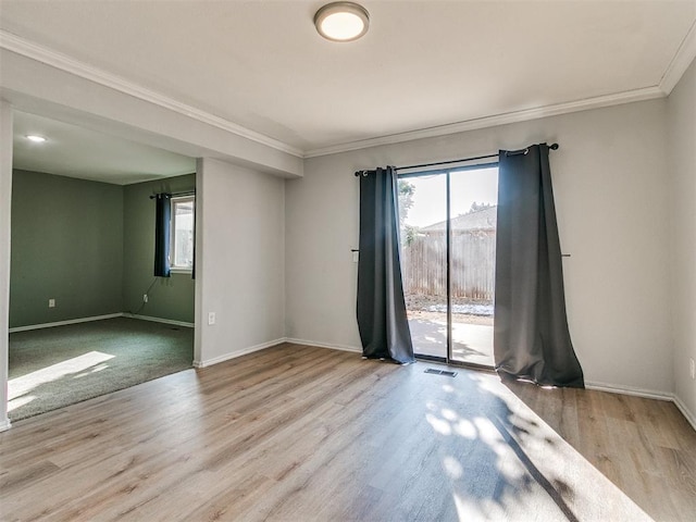 empty room featuring ornamental molding, light wood-type flooring, and golf simulator