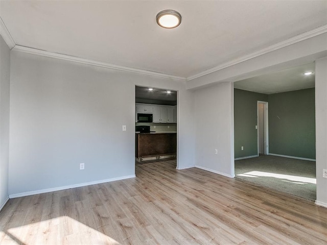 unfurnished room featuring crown molding and light hardwood / wood-style flooring