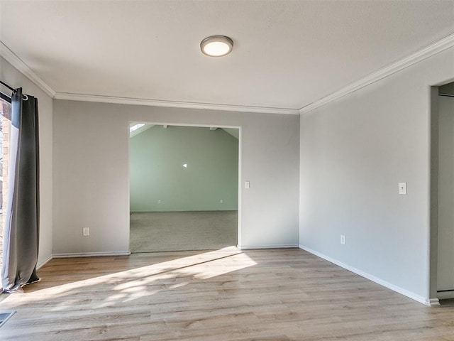 empty room featuring light hardwood / wood-style flooring and crown molding