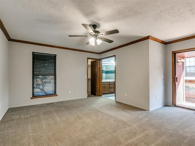 unfurnished room with a textured ceiling, light carpet, ceiling fan, and crown molding