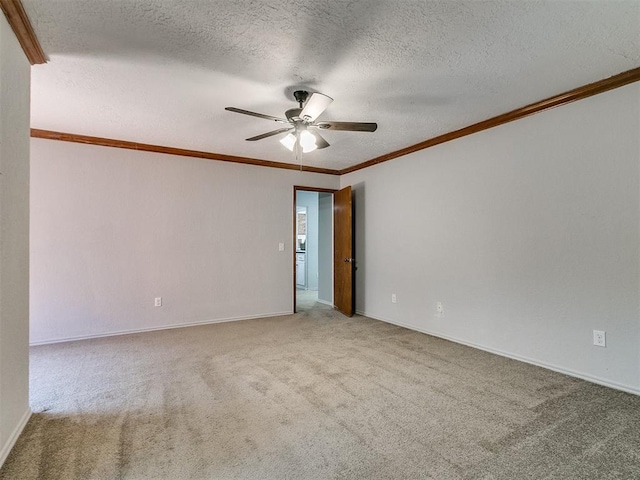 carpeted empty room featuring a textured ceiling, ceiling fan, and crown molding