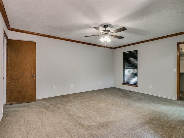 carpeted spare room featuring a textured ceiling, ceiling fan, and ornamental molding