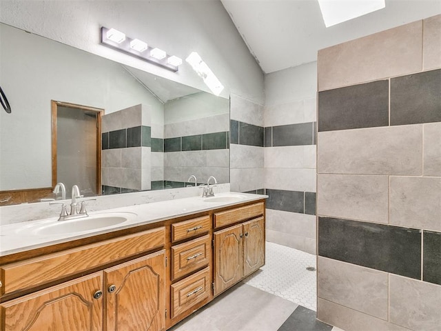 bathroom with tile walls, walk in shower, and vanity