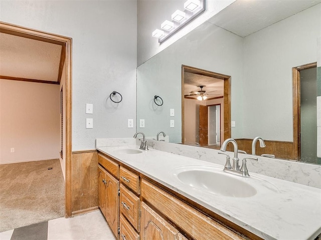 bathroom with vanity, wooden walls, and ceiling fan