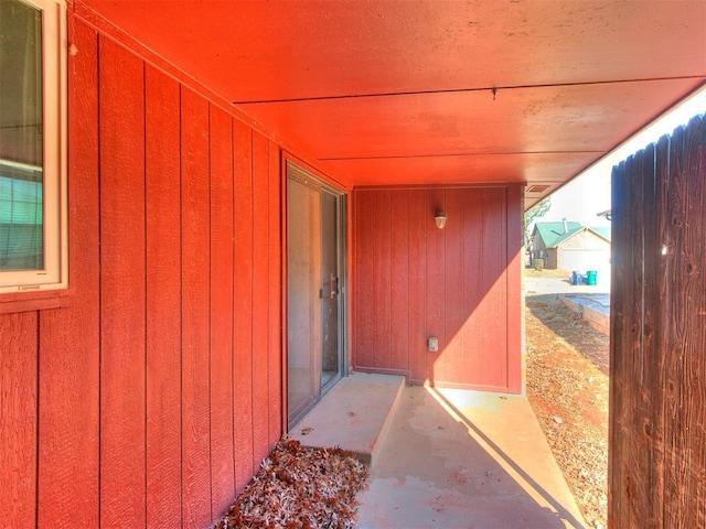 view of exterior entry with a patio area