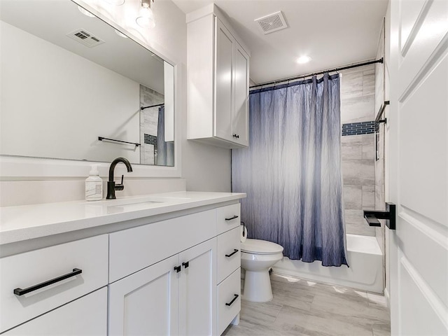 full bathroom with vanity, toilet, and shower / tub combo