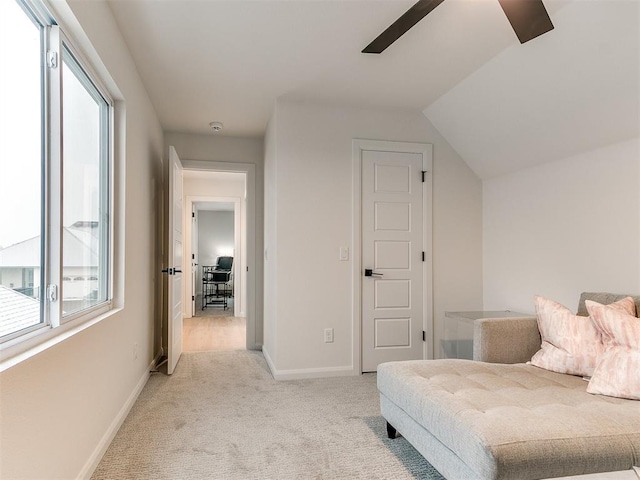 bedroom with ceiling fan, light colored carpet, multiple windows, and vaulted ceiling