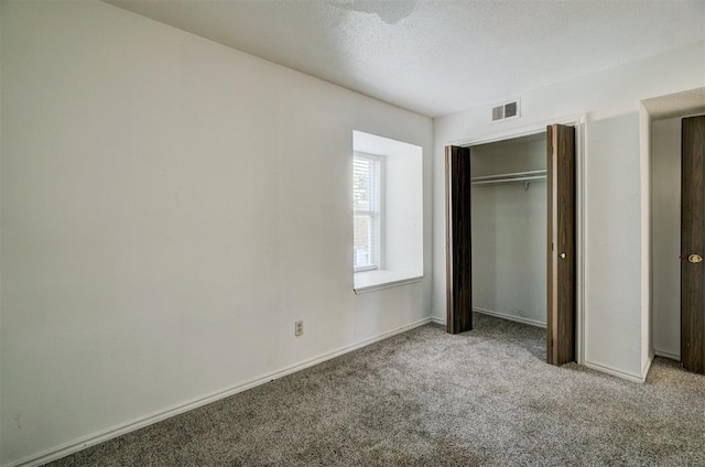 unfurnished bedroom with carpet and a closet