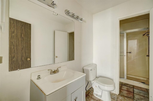 bathroom featuring vanity, toilet, and walk in shower