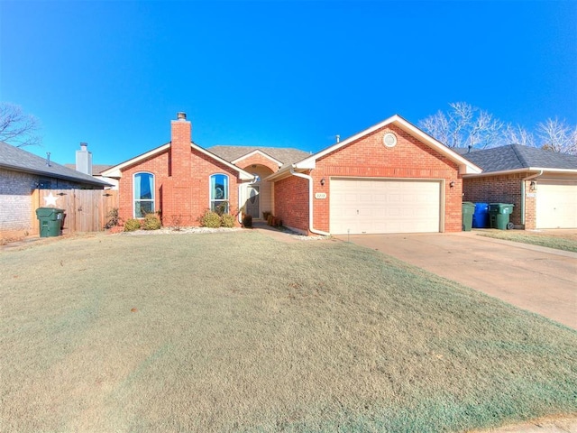 single story home featuring a garage and a front lawn