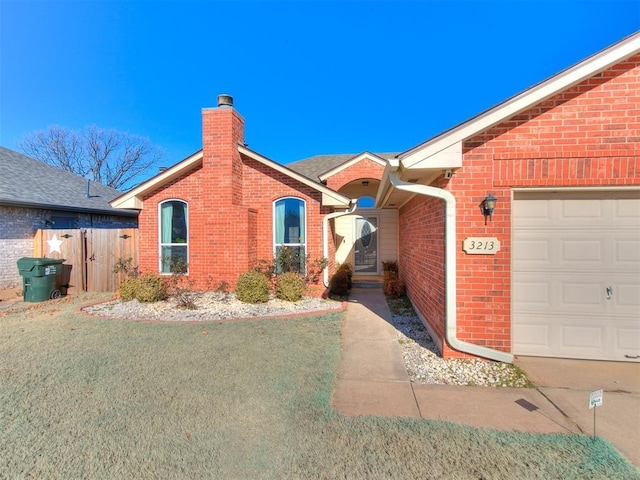 single story home with a garage and a front yard