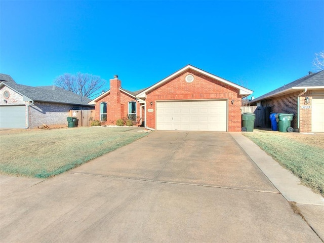 ranch-style house featuring a front yard and a garage