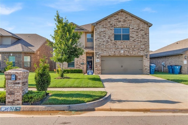 view of front of home with a garage, a front lawn, concrete driveway, and brick siding