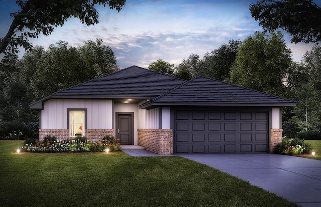 view of front of home with brick siding, an attached garage, concrete driveway, and a front yard