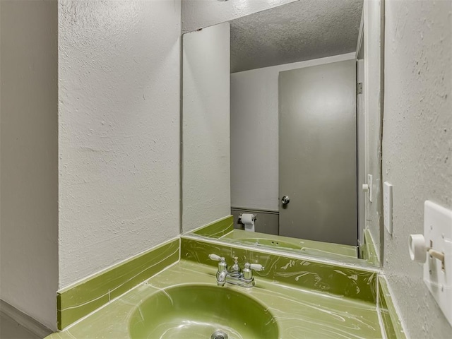 bathroom featuring vanity and a textured ceiling