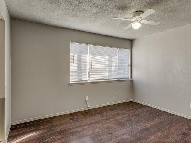 empty room with ceiling fan and dark hardwood / wood-style flooring