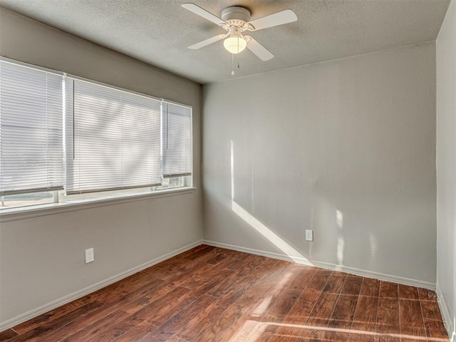 spare room featuring ceiling fan and dark wood-type flooring