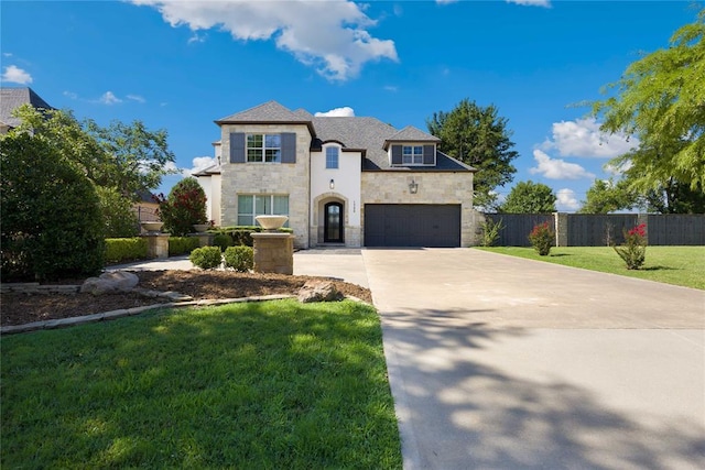 view of front of home featuring a front lawn and a garage