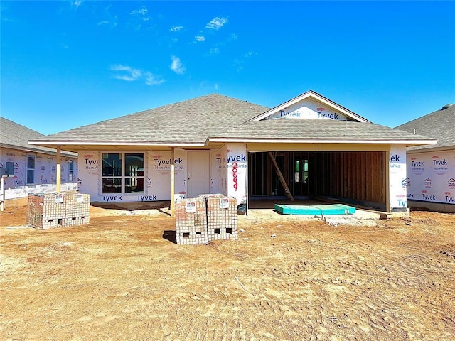 property under construction with roof with shingles