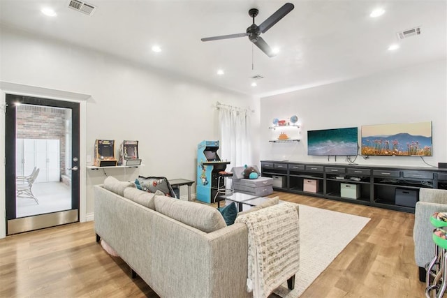 living room featuring light hardwood / wood-style flooring and ceiling fan