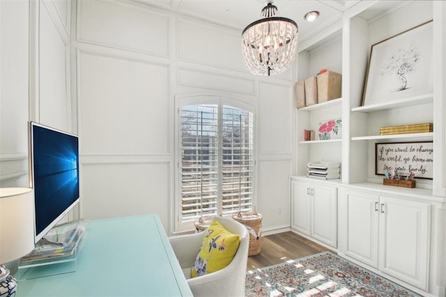 office area featuring an inviting chandelier and hardwood / wood-style floors