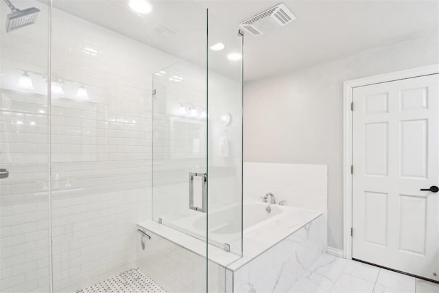 bathroom featuring separate shower and tub