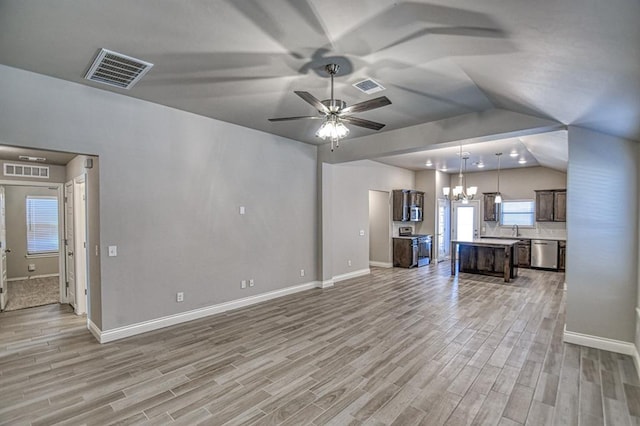 unfurnished living room featuring ceiling fan with notable chandelier, light hardwood / wood-style flooring, vaulted ceiling, and sink