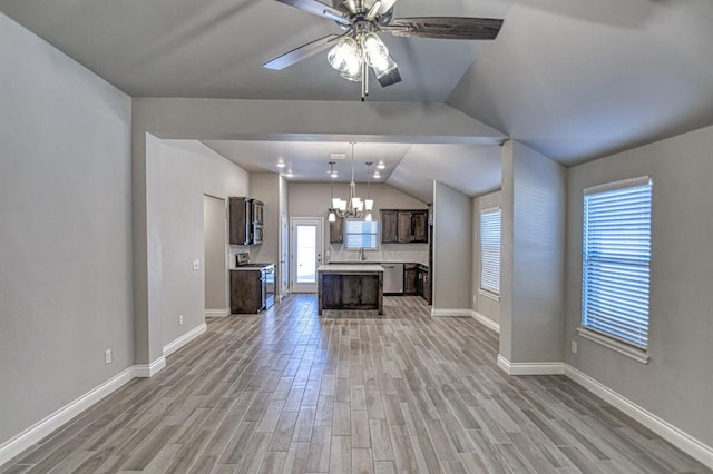 unfurnished living room with ceiling fan with notable chandelier, light wood-type flooring, and lofted ceiling