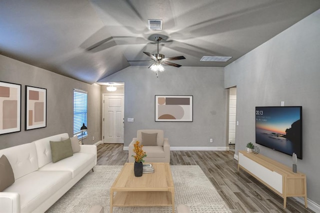 living room with ceiling fan, wood-type flooring, and vaulted ceiling