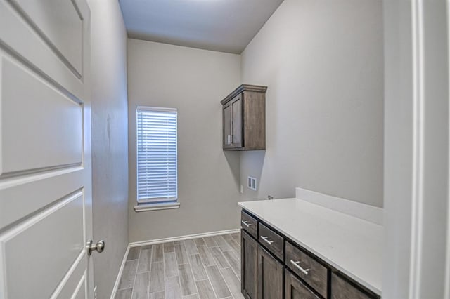 laundry room with light hardwood / wood-style flooring, cabinets, and washer hookup