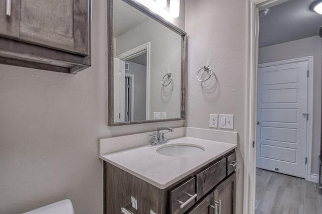 bathroom with hardwood / wood-style floors and vanity