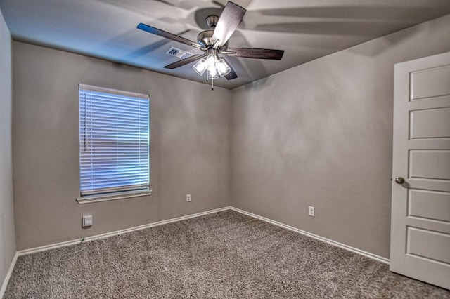 carpeted spare room with ceiling fan