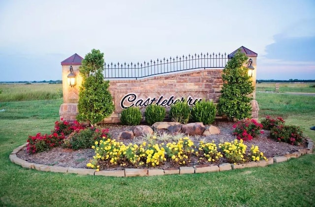 community / neighborhood sign with a rural view