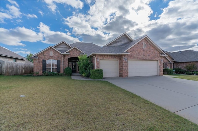 view of front of home with a front yard and a garage