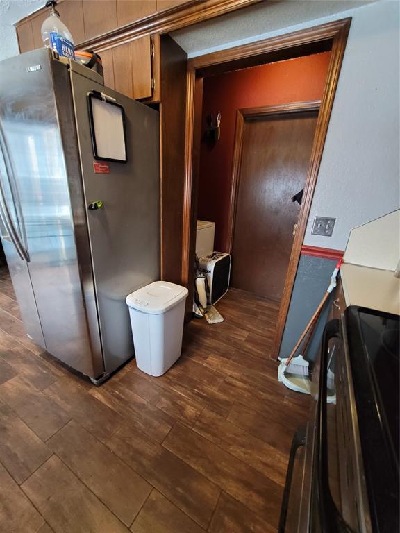 corridor with dark hardwood / wood-style flooring